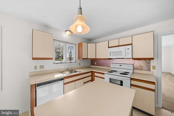 a kitchen that has a sink and a stove