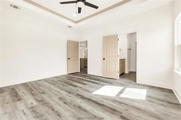 a view of empty room with wooden floor