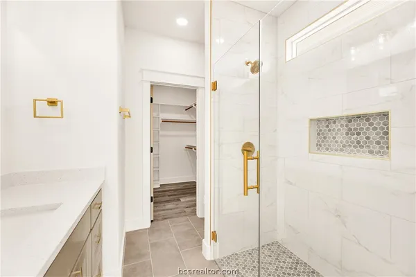 a bathroom with a shower and a sink