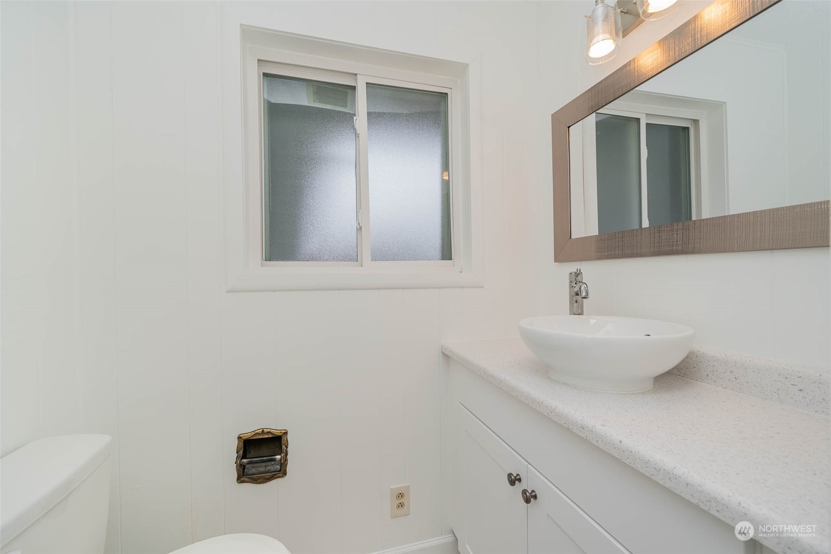 1709 Edmonds Avenue Northeast Renton, WA 98056 - Photo 13 of 31 a bathroom with a sink and a mirror