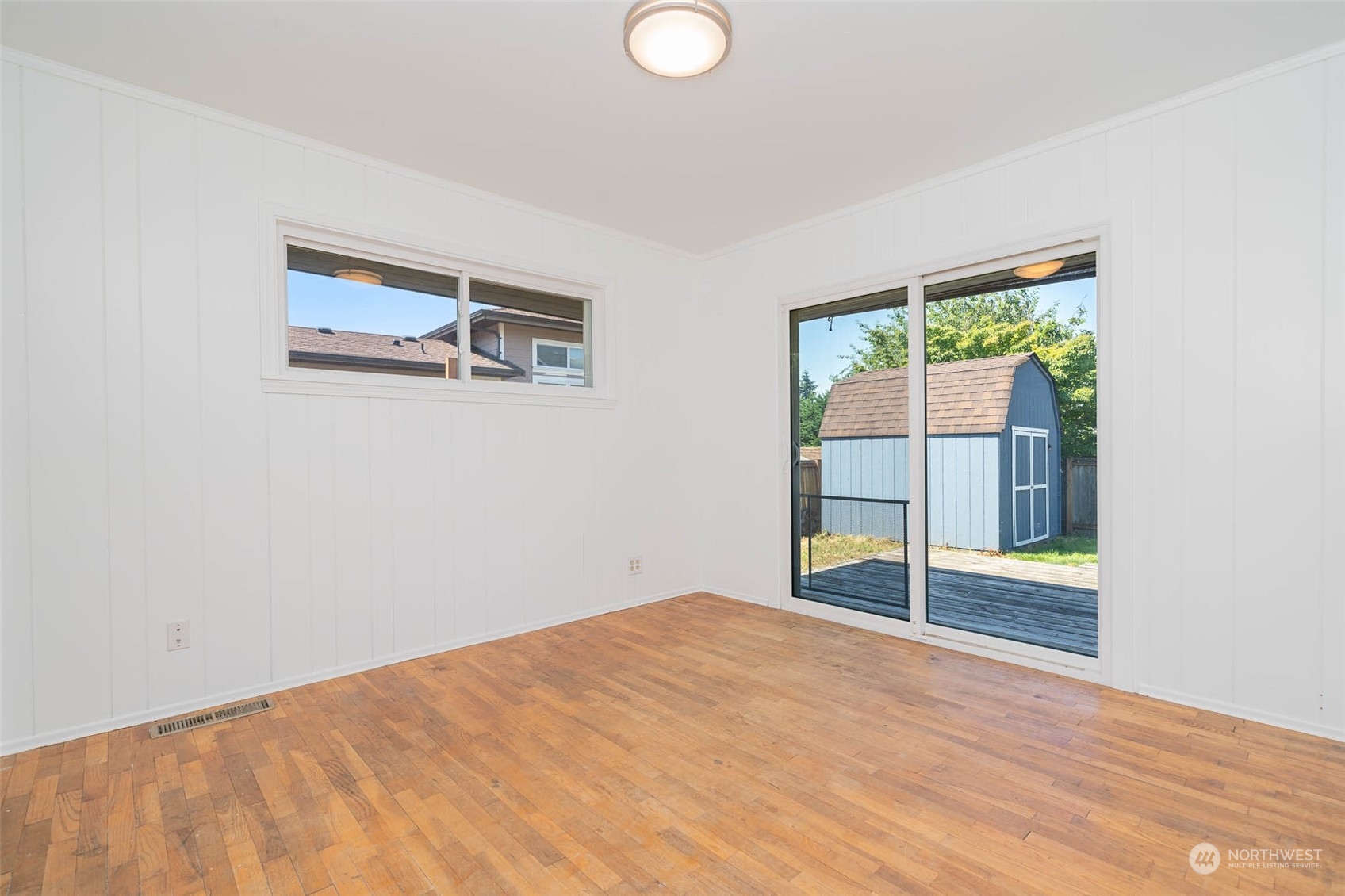 1709 Edmonds Avenue Northeast Renton, WA 98056 - Photo 14 of 31 a view of an empty room with wooden floor and a window