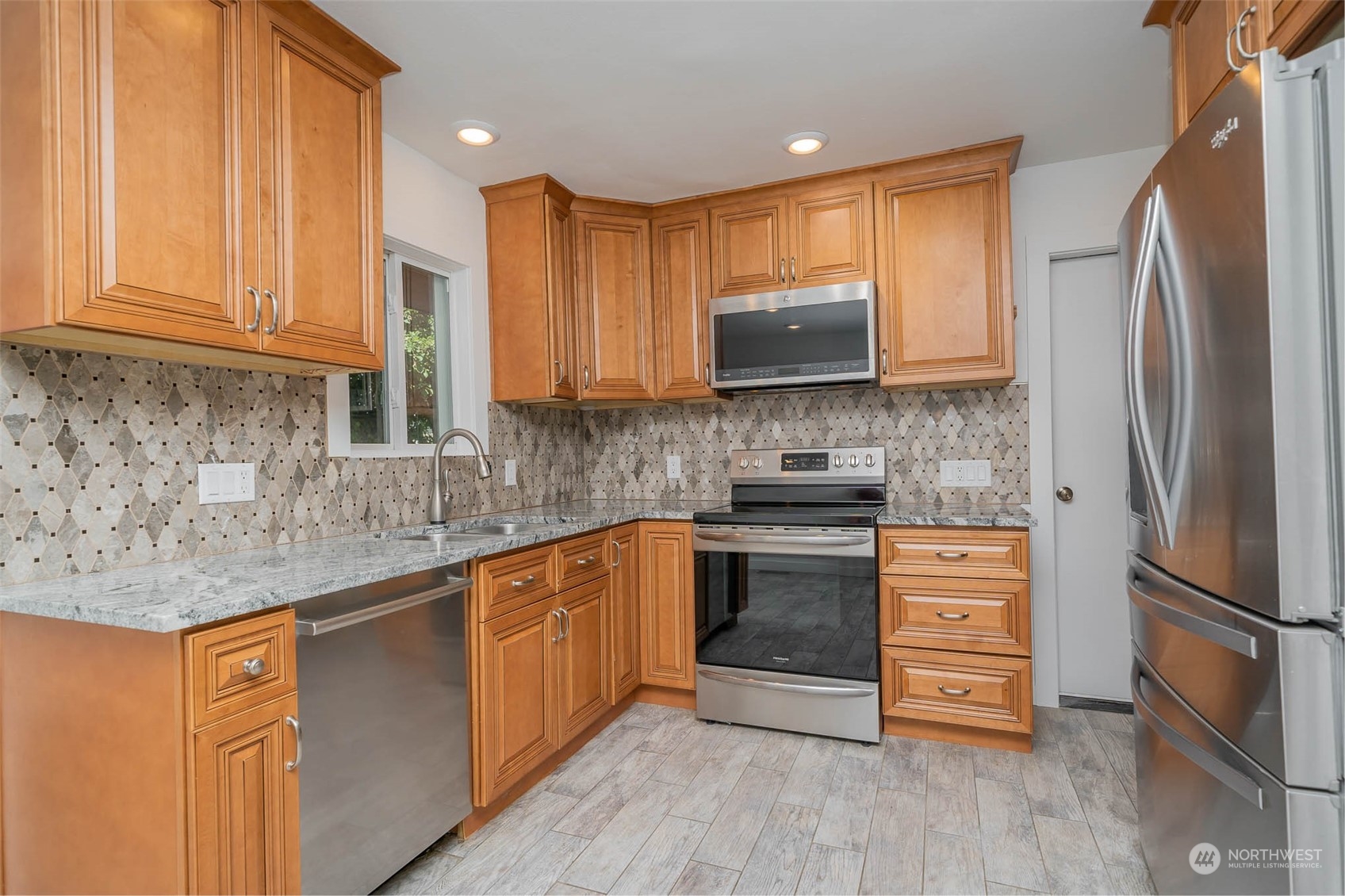 1709 Edmonds Avenue Northeast Renton, WA 98056 - Photo 7 of 31 a kitchen with stainless steel appliances granite countertop a refrigerator sink and microwave