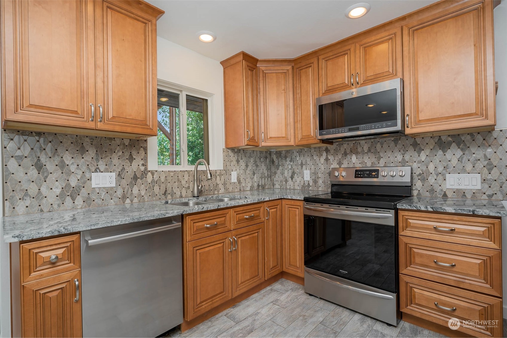1709 Edmonds Avenue Northeast Renton, WA 98056 - Photo 8 of 31 a kitchen with stainless steel appliances granite countertop a sink stove and microwave