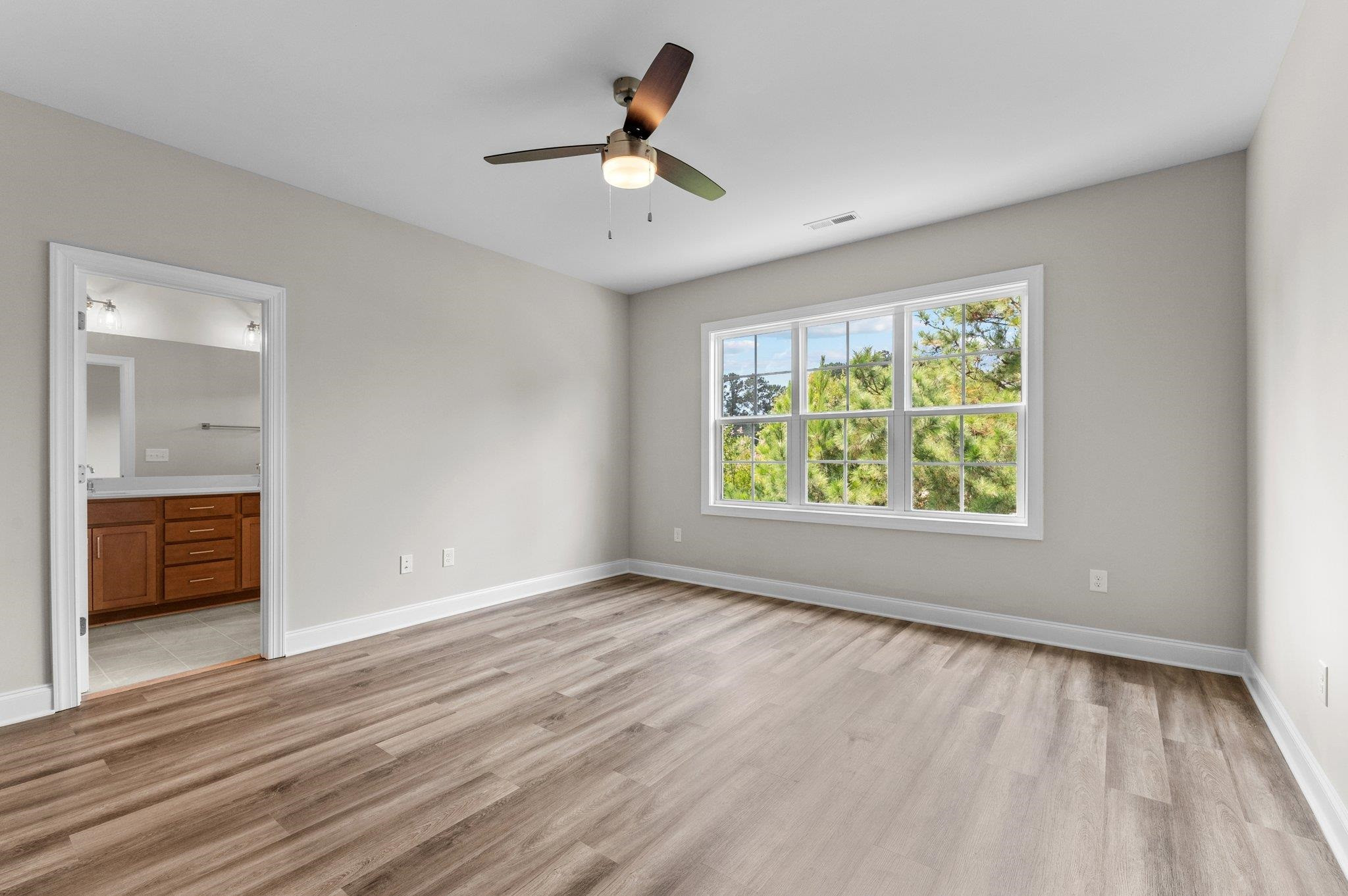 609 Marshskip Way, Unit 5 Rolesville, NC 27571 - Photo 11 of 39 wooden floor in an empty room with a window