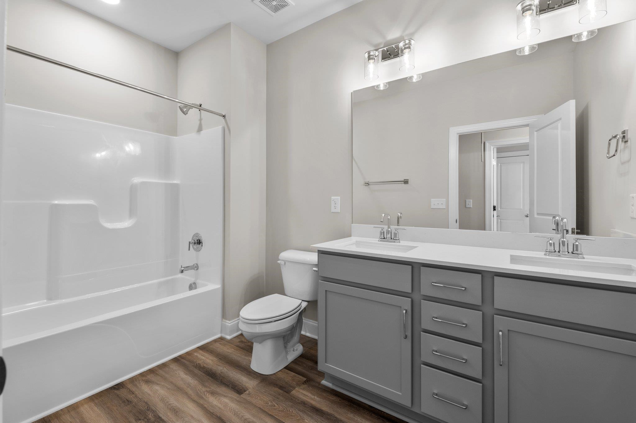 609 Marshskip Way, Unit 5 Rolesville, NC 27571 - Photo 17 of 39 a bathroom with a sink toilet a shower and a mirror
