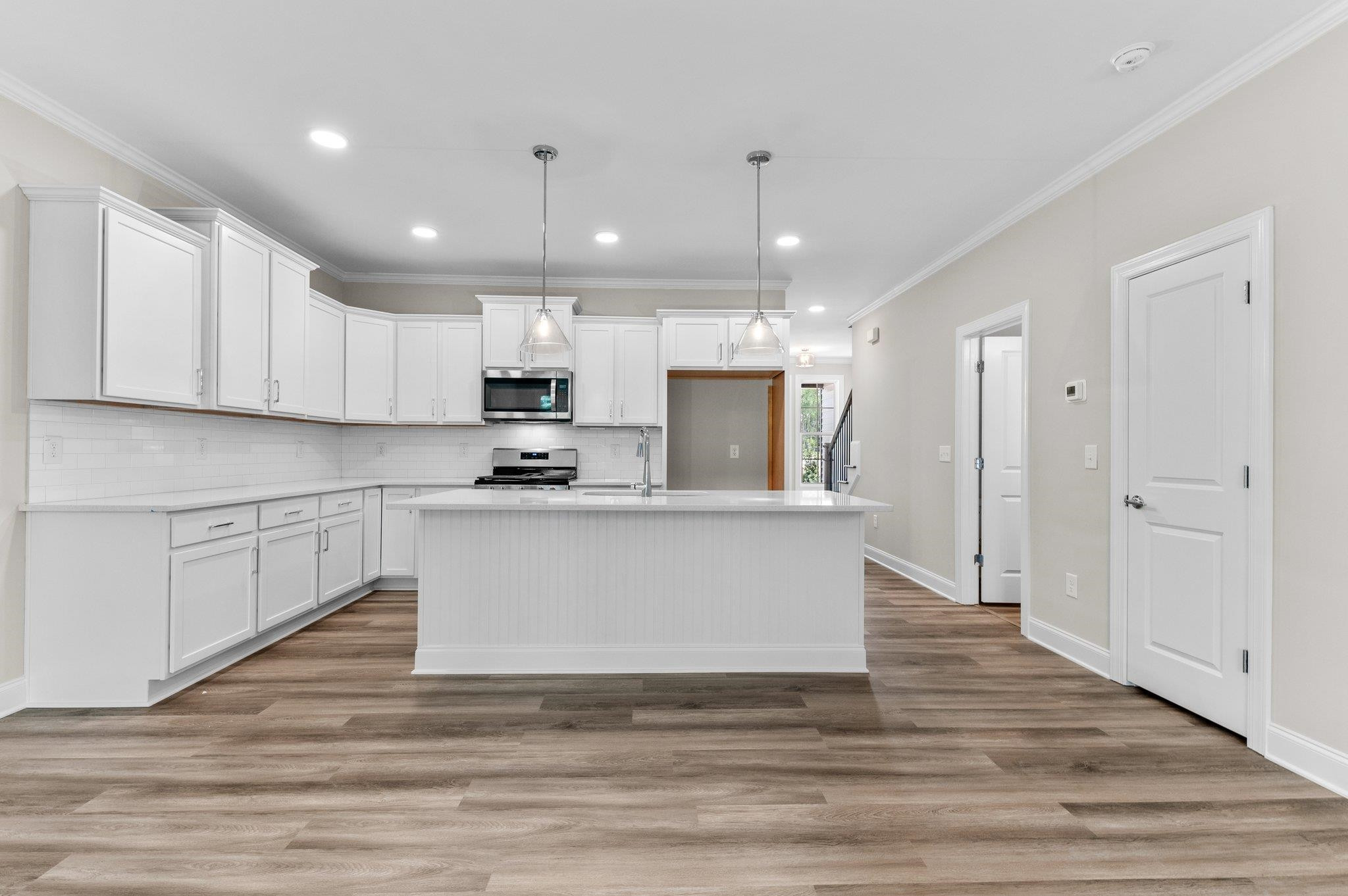 609 Marshskip Way, Unit 5 Rolesville, NC 27571 - Photo 2 of 39 a view of kitchen with stainless steel appliances granite countertop refrigerator oven stove and white cabinets with wooden floor
