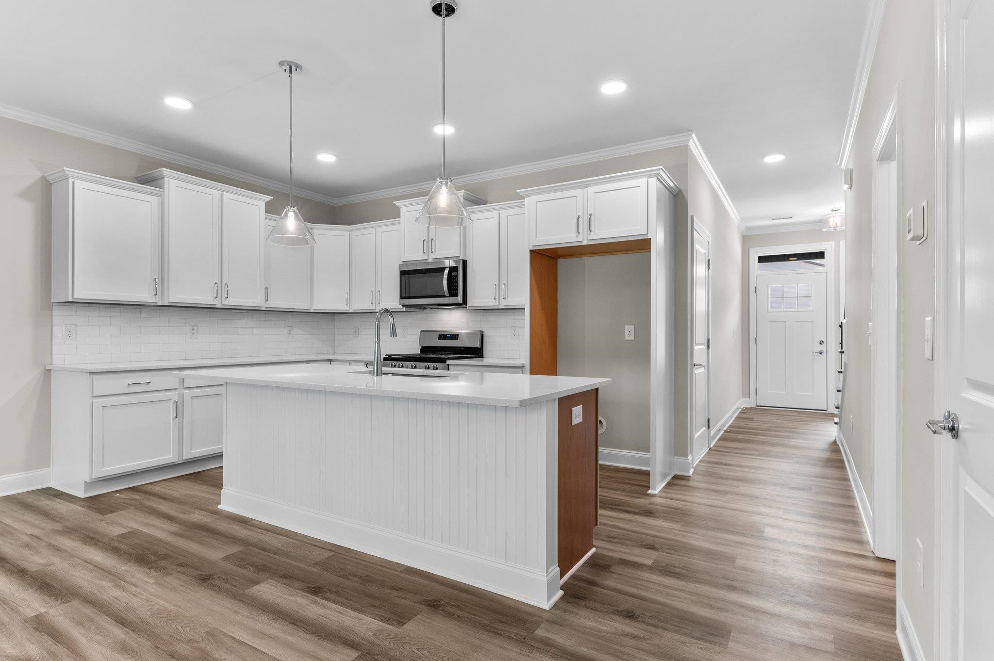609 Marshskip Way, Unit 5 Rolesville, NC 27571 - Photo 3 of 39 a kitchen with kitchen island a sink stainless steel appliances and cabinets