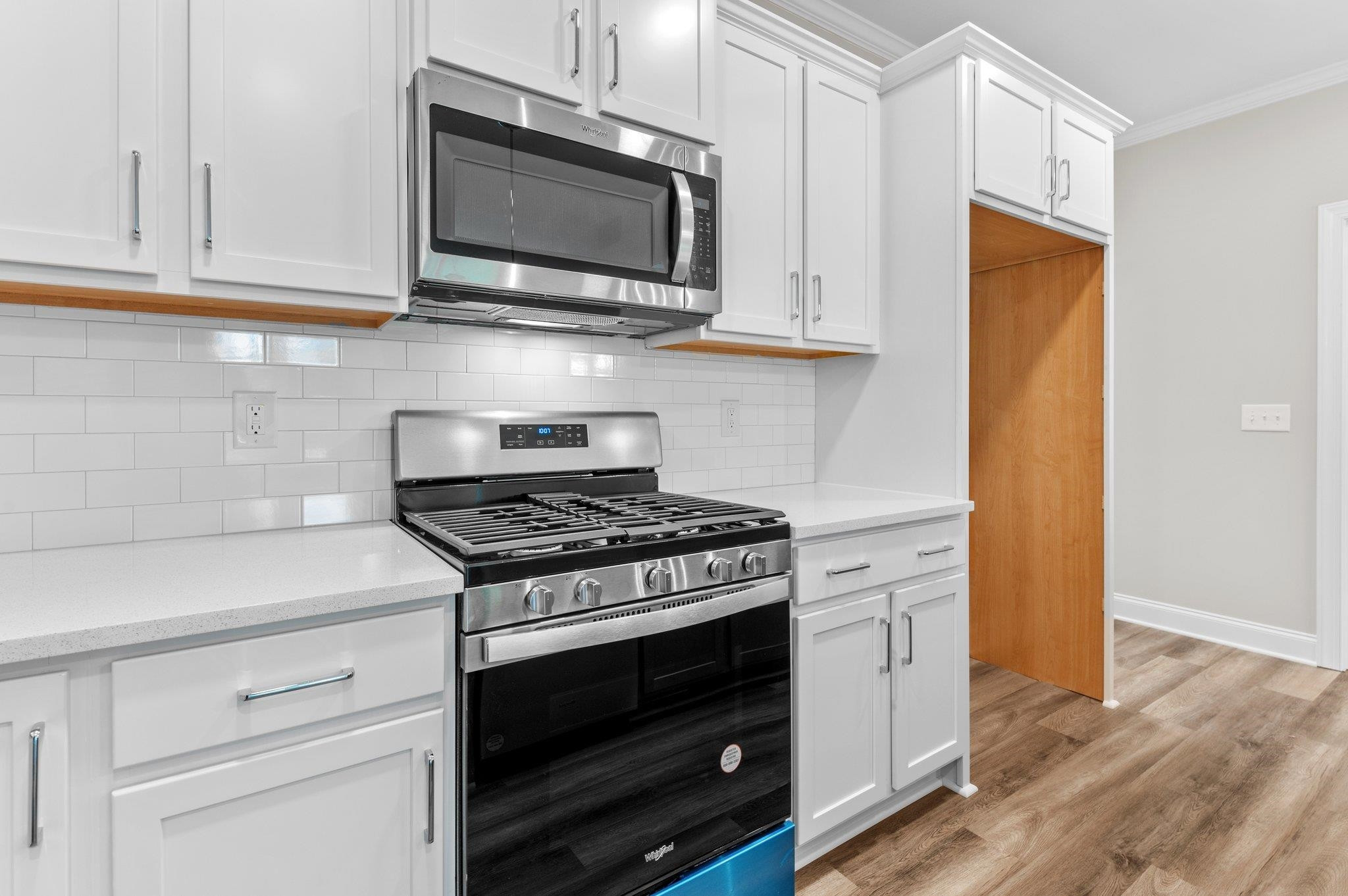 609 Marshskip Way, Unit 5 Rolesville, NC 27571 - Photo 5 of 39 a kitchen with stainless steel appliances white cabinets and a stove top oven