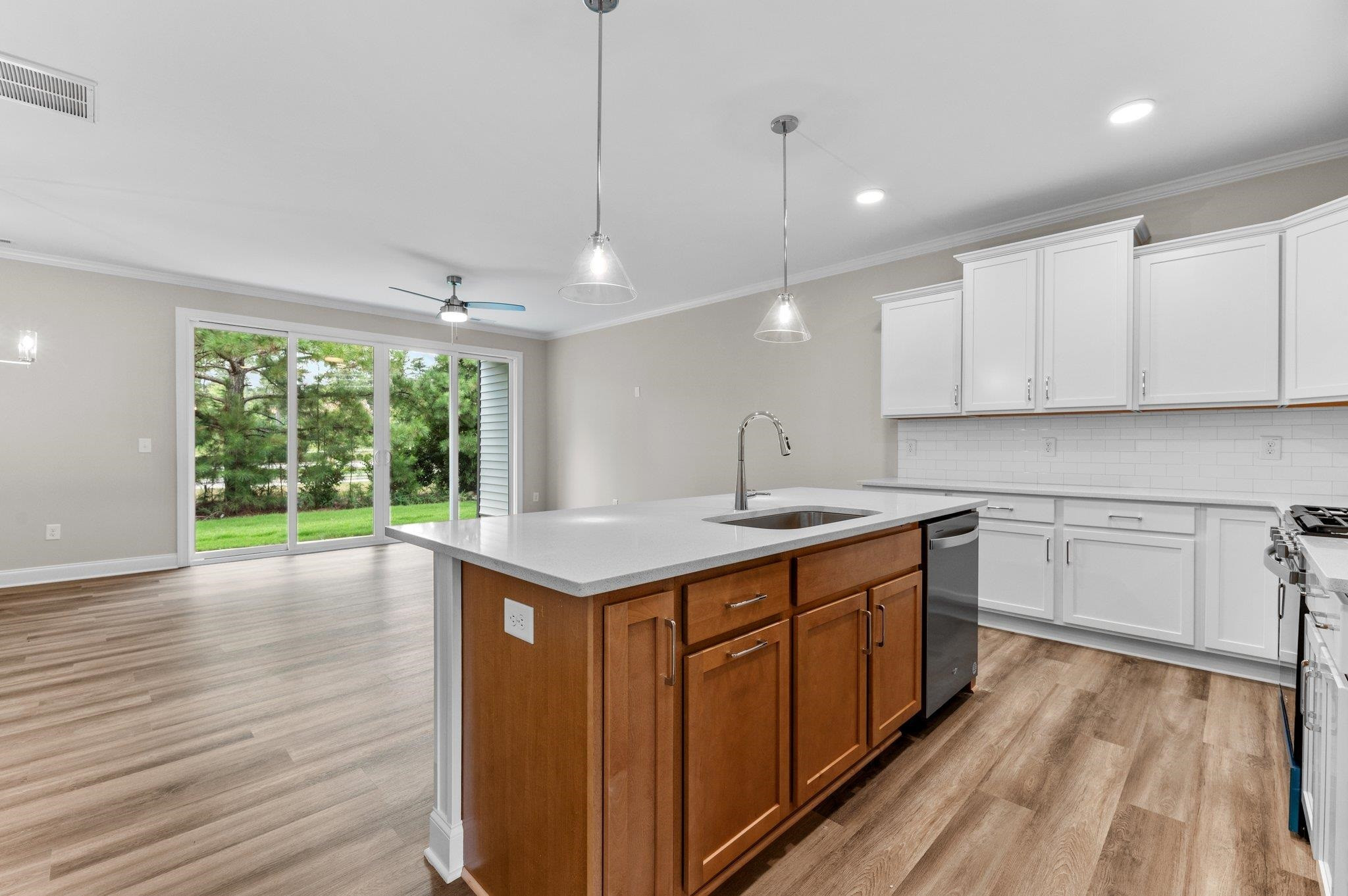 609 Marshskip Way, Unit 5 Rolesville, NC 27571 - Photo 7 of 39 a kitchen with a sink window and cabinets