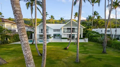 a house view with a garden space and swimming pool