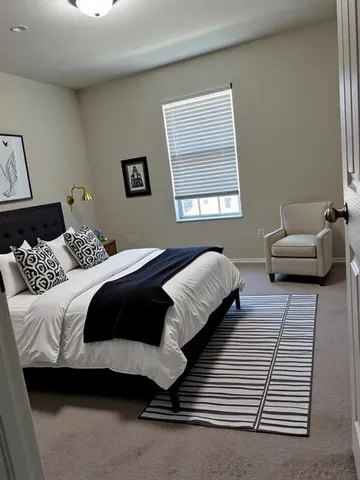 a bedroom with a bed and a couch