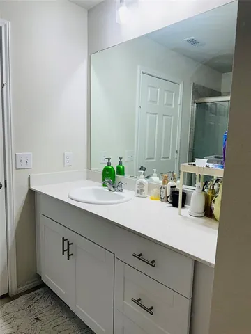 a bathroom with a sink and a mirror