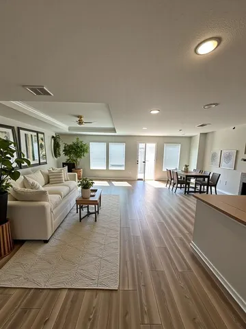 a living room with furniture and a wooden floor