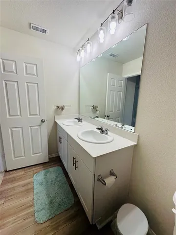 a bathroom with a sink toilet and mirror