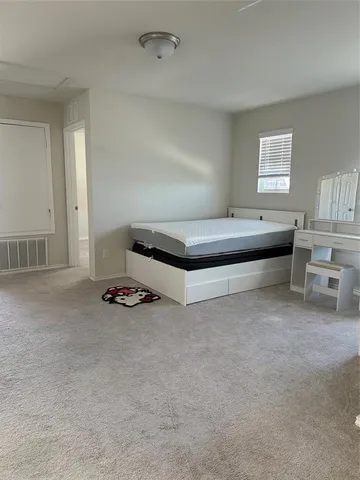 a bedroom with furniture and window