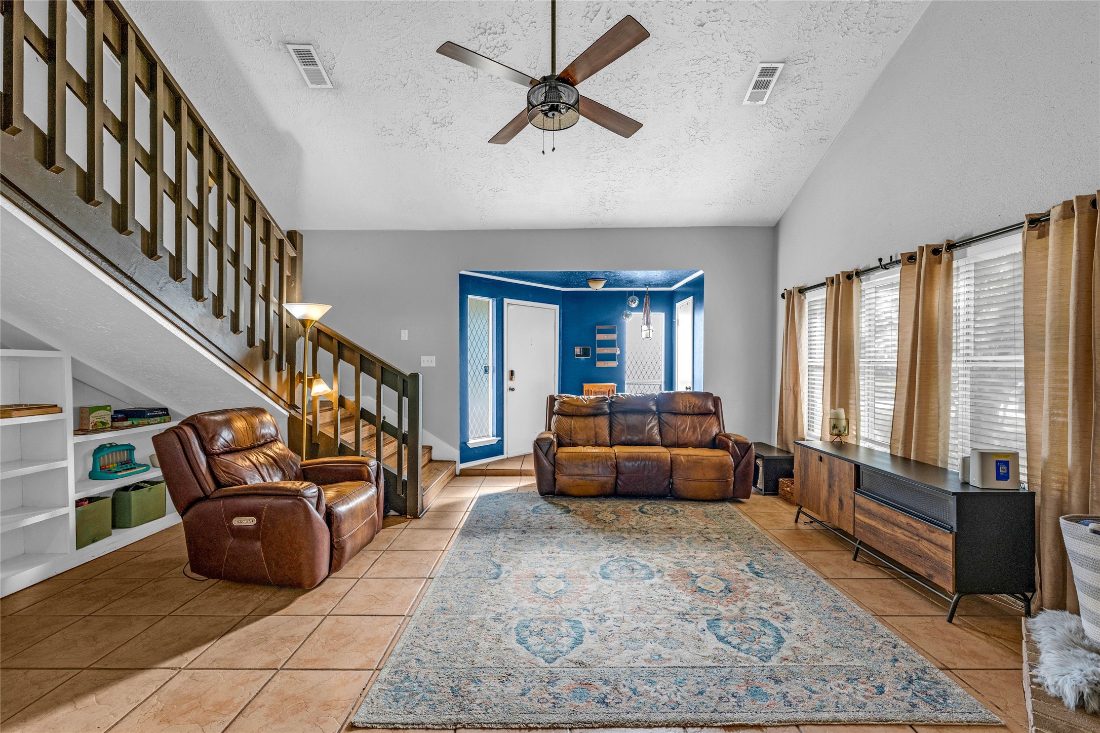 24014 Red Sky Drive Spring, TX 77373 - Photo 3 of 23 a living room with furniture ceiling fan and a rug