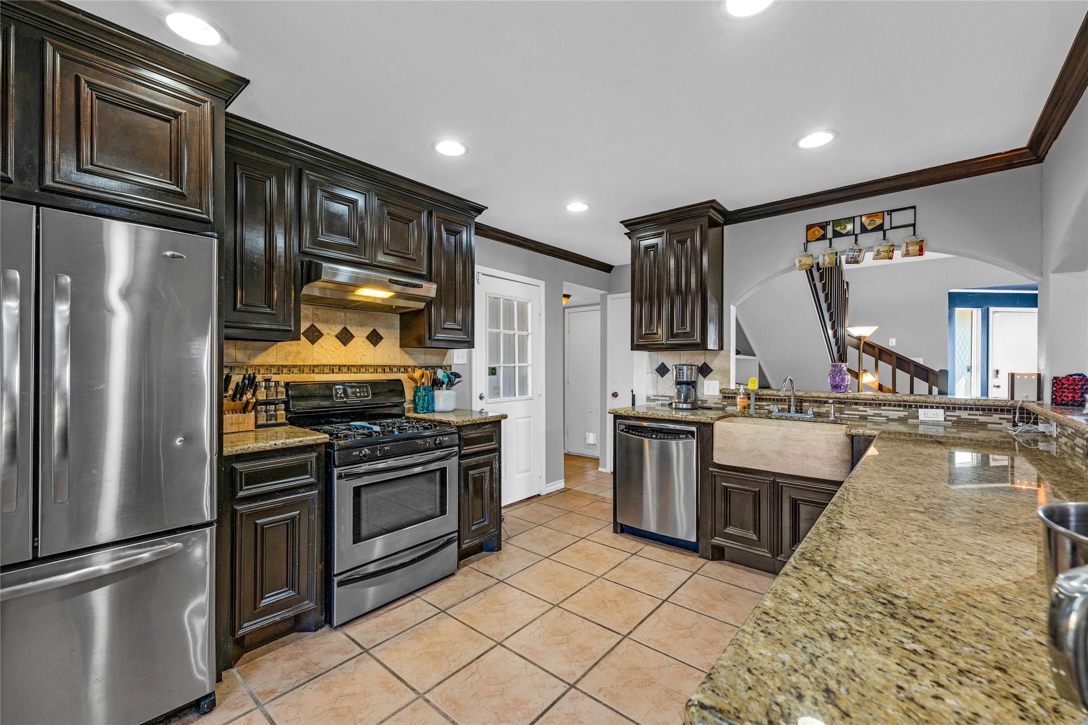 24014 Red Sky Drive Spring, TX 77373 - Photo 9 of 23 a kitchen with stainless steel appliances granite countertop a refrigerator a stove and a sink