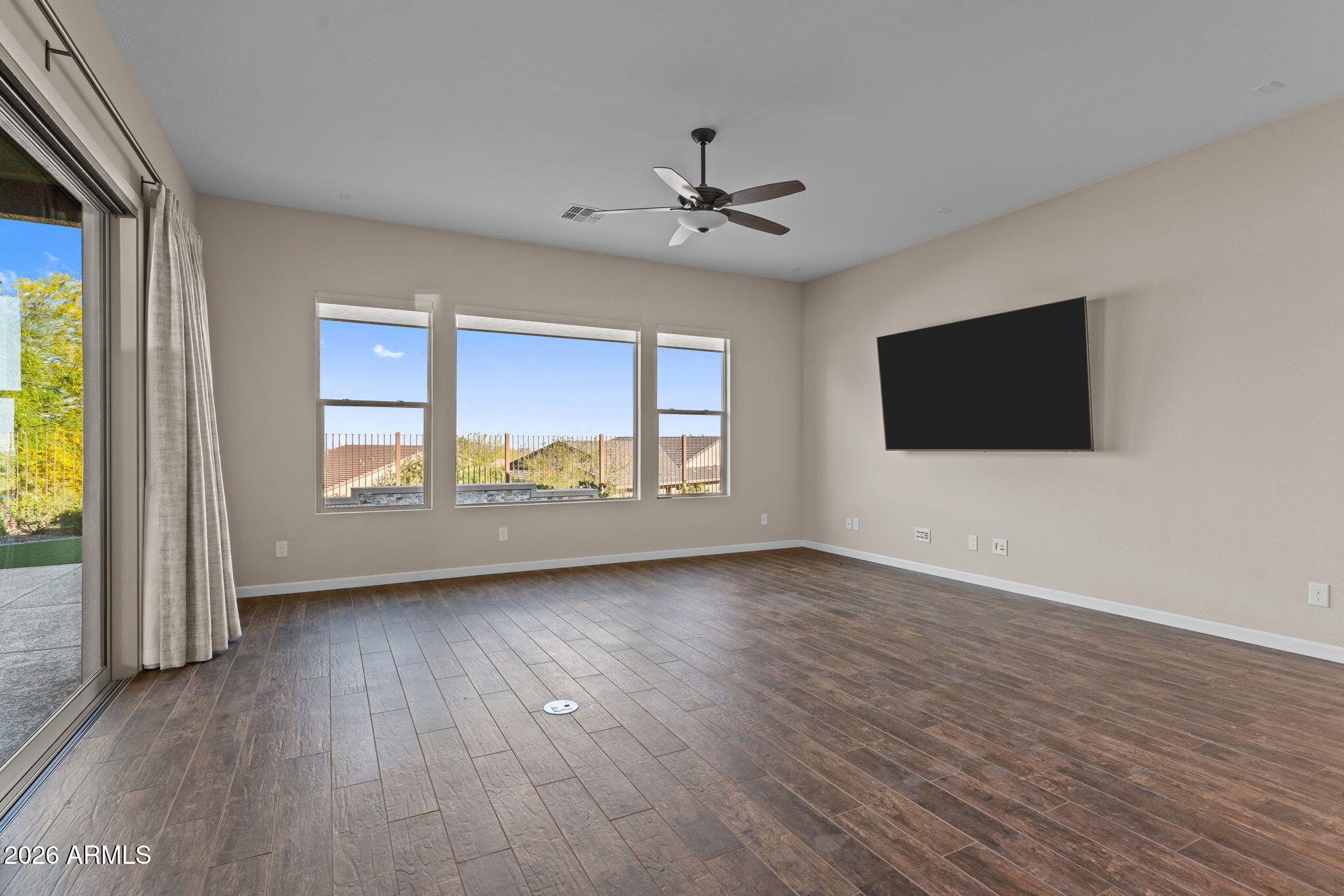 3675 Gold Ridge Road Wickenburg, AZ 85390 - Photo 18 of 58 an empty room with wooden floor fan and windows