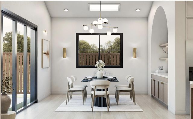 a dining room with furniture a chandelier and window