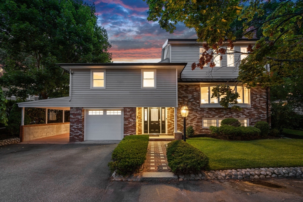 13 Doane Road Medford, MA 02155 - Photo 1 of 42 a front view of a house with a yard and garage