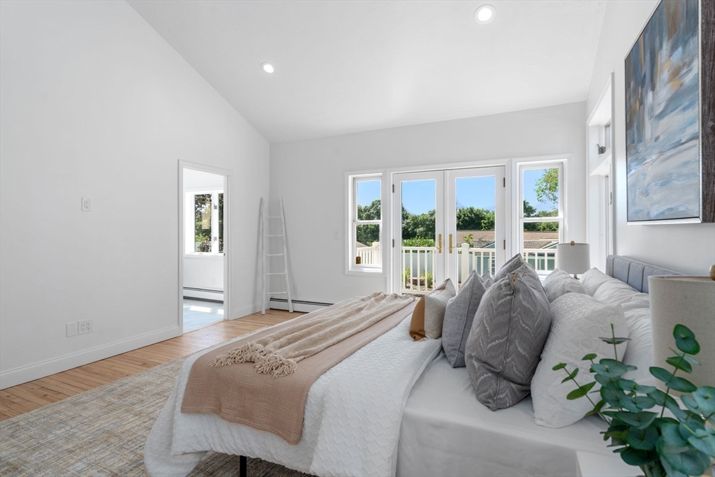 13 Doane Road Medford, MA 02155 - Photo 17 of 42 a bedroom with a bed and a potted plant