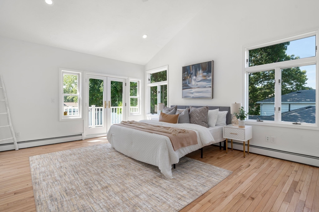 13 Doane Road Medford, MA 02155 - Photo 18 of 42 a spacious bedroom with a large bed and a large window