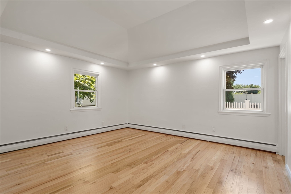 13 Doane Road Medford, MA 02155 - Photo 21 of 42 a view of an empty room with wooden floor and a window