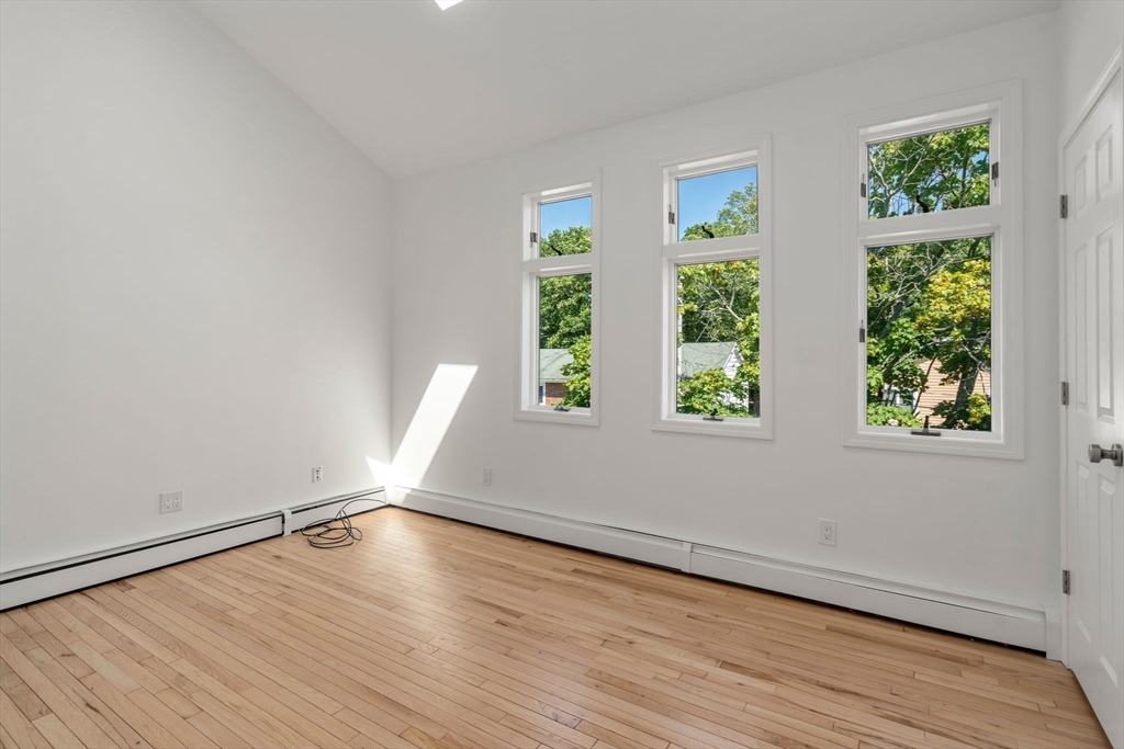 13 Doane Road Medford, MA 02155 - Photo 22 of 42 a view of room with window and wooden floor