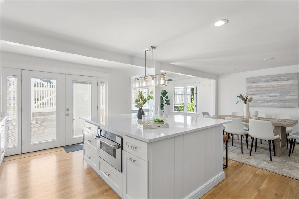 13 Doane Road Medford, MA 02155 - Photo 3 of 42 a kitchen with kitchen island granite countertop a table and chairs in it
