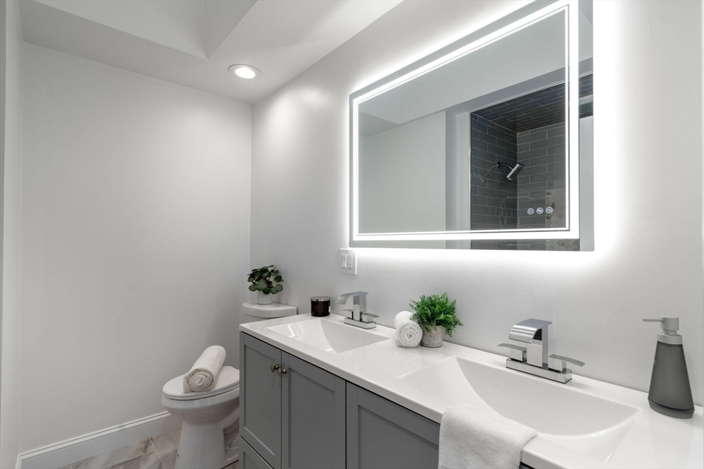 13 Doane Road Medford, MA 02155 - Photo 31 of 42 a bathroom with a sink toilet and a mirror