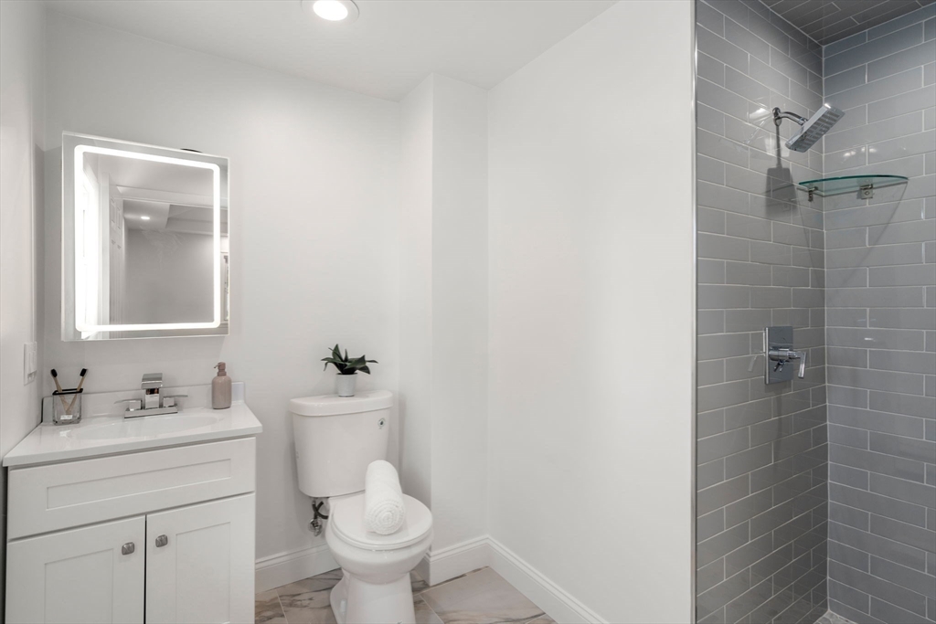 13 Doane Road Medford, MA 02155 - Photo 32 of 42 a bathroom with a sink toilet and shower