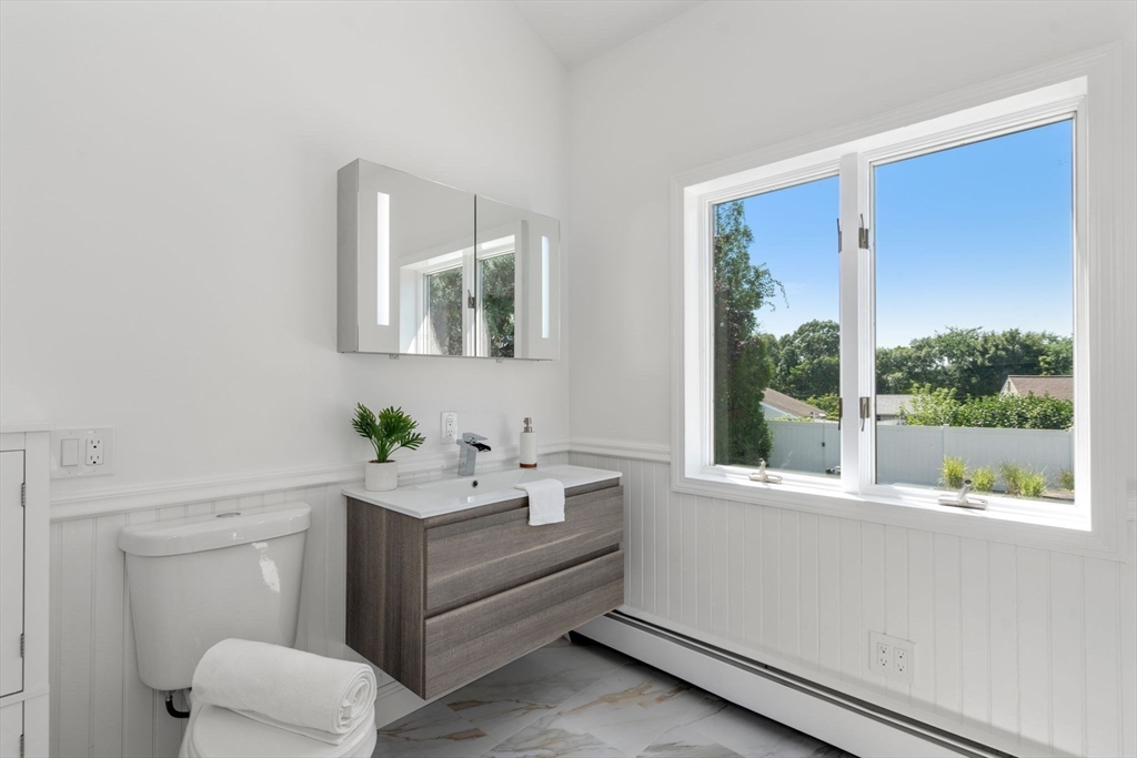 13 Doane Road Medford, MA 02155 - Photo 34 of 42 a bathroom with a sink mirror and a window