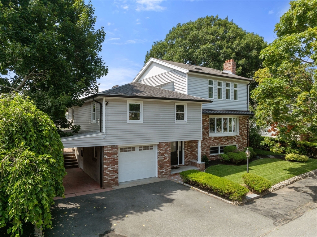 13 Doane Road Medford, MA 02155 - Photo 38 of 42 a front view of a house with a yard and garage