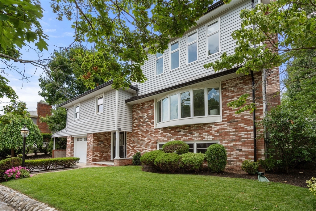 13 Doane Road Medford, MA 02155 - Photo 39 of 42 a front view of a house with a garden