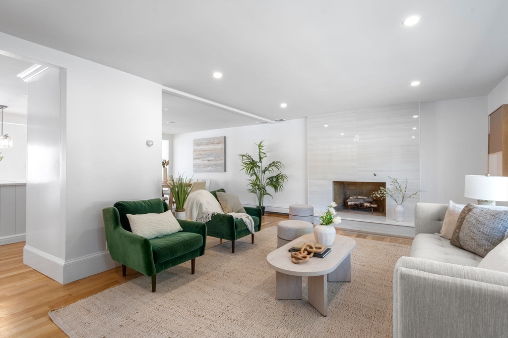 13 Doane Road Medford, MA 02155 - Photo 10 of 42 a living room with furniture a fireplace and a potted plant