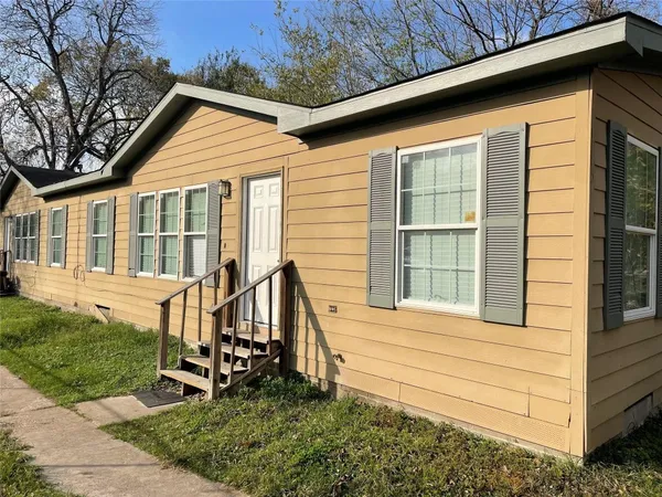a view of house with a yard
