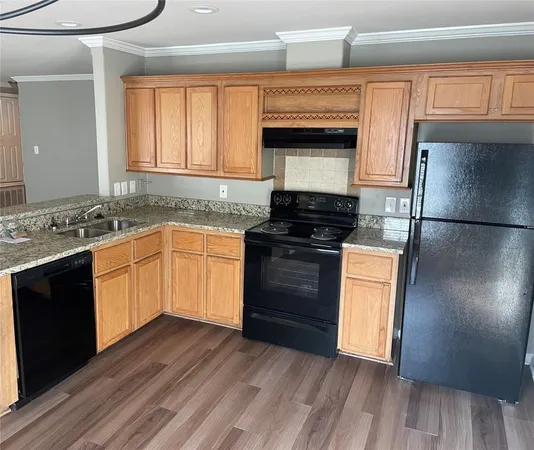 a kitchen with granite countertop wooden cabinets and a stove