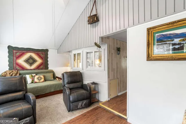 a bedroom with a bed mirror and window