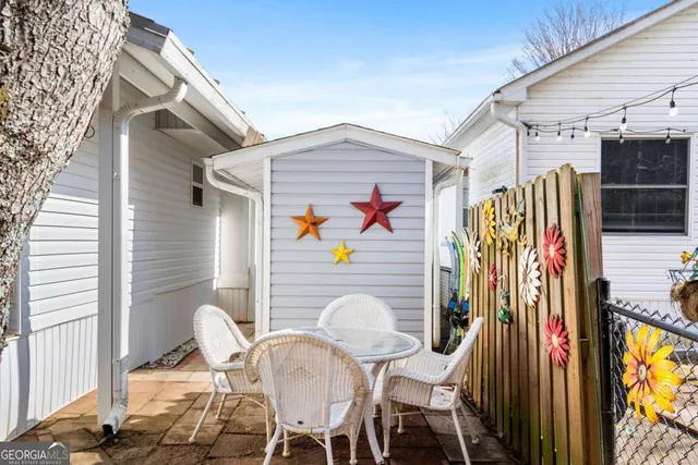 a view of a house with a backyard and sitting area