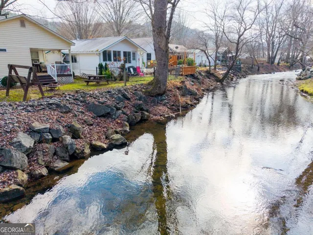 a kitchen with stainless steel appliances granite countertop a stove microwave and cabinets
