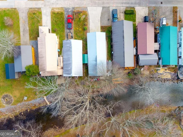 a view of residential houses with yard and entertaining space