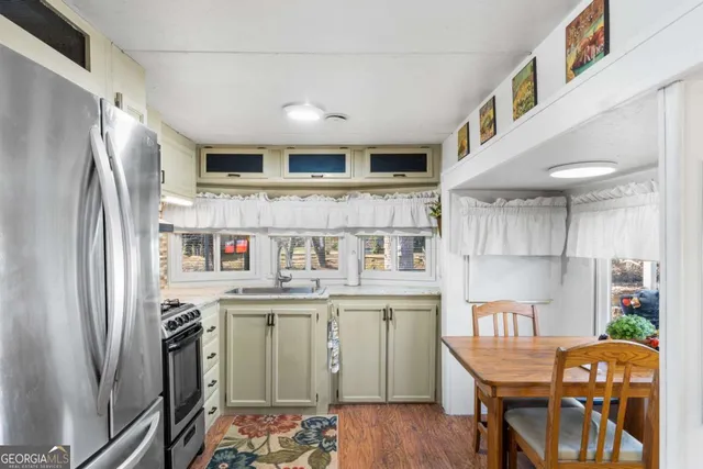 a bedroom with furniture and a painting on the wall