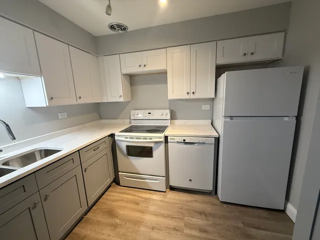 a white refrigerator freezer sitting in a kitchen