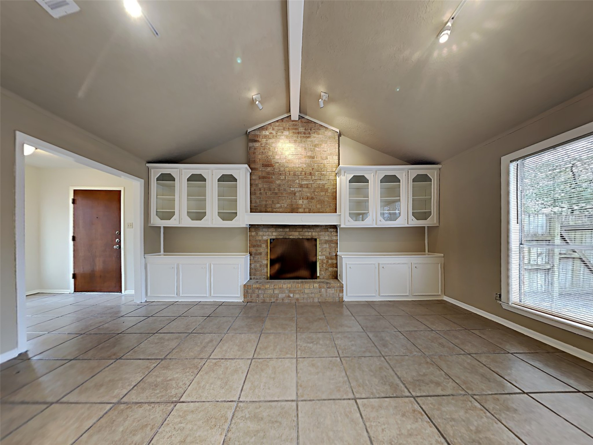 603 Blue Ridge Drive Shenandoah, TX 77381 - Photo 3 of 17 a view of an empty room with a fireplace and a window