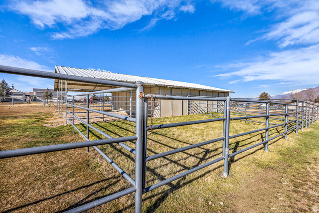 1060 West 2620th Street South Mapleton, UT 84664 - Photo 64 of 87 View of yard featuring an outbuilding, an exterior structure, a rural view, and a mountain view