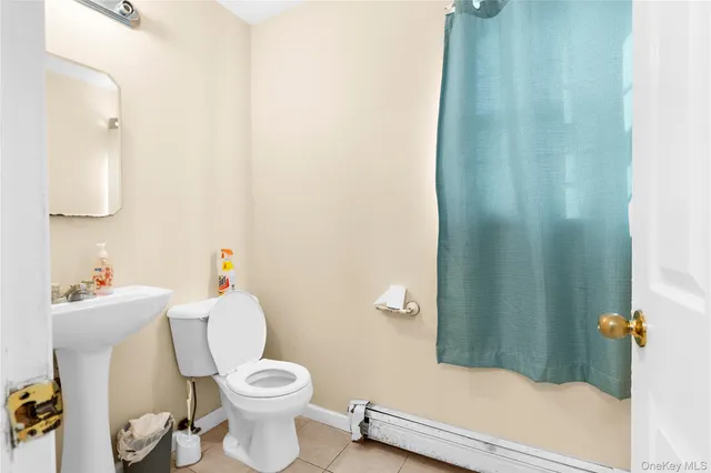 a white toilet sitting next to a bathroom sink