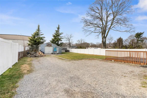a view of a yard with large trees