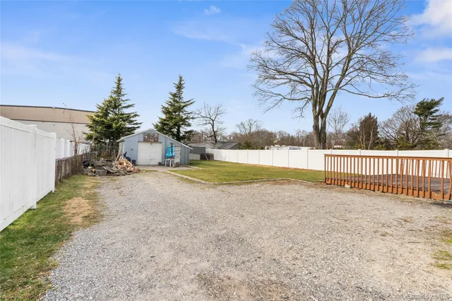 a view of a yard with large trees