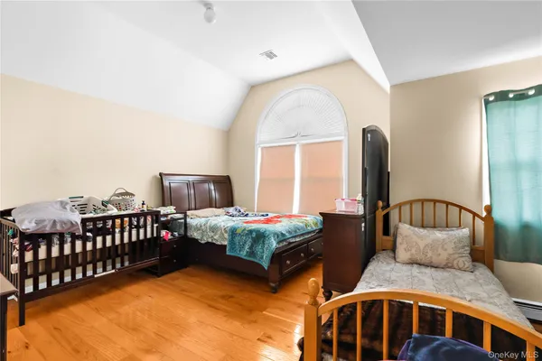 a bedroom with two beds and window