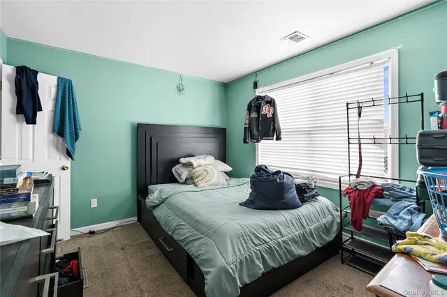 a bedroom with a bed and windows